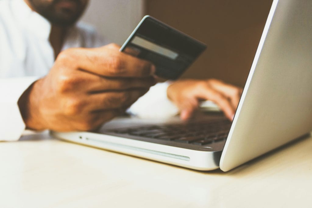 Online shopper paying by card on a laptop